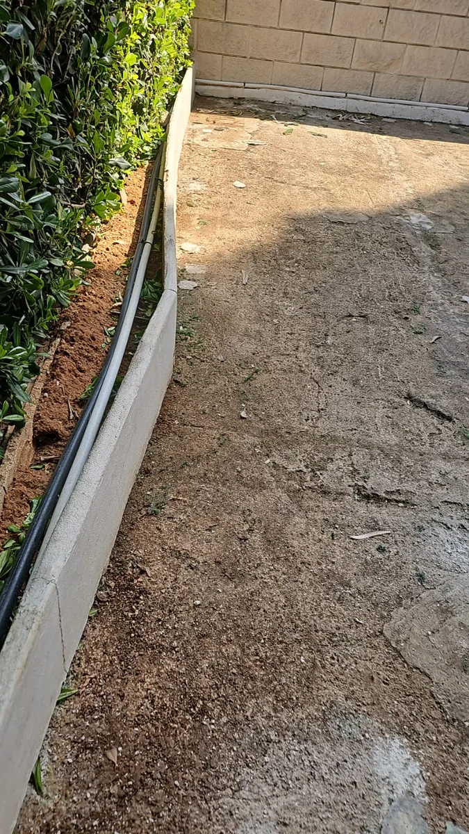 Solera de hormigón y zócalo de un parque infantil de Dénia antes de instalar césped artificial